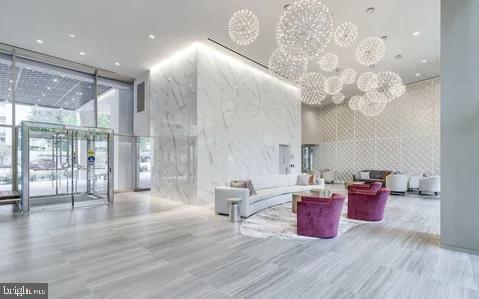 4620 N Park Ave N Unit 502W, Chevy Chase, MD 20815 - building lobby with a wall of windows, a towering ceiling, and recessed lighting