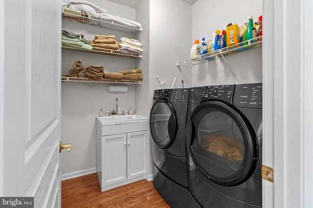 14 Mcconkey Dr, Washington Crossing, PA 18977 - laundry area featuring washing machine and clothes dryer, light wood-type flooring, and cabinet space