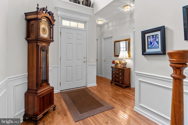 14 Mcconkey Dr, Washington Crossing, PA 18977 - foyer entrance with light wood finished floors, a wainscoted wall, and a decorative wall