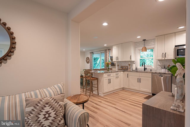 120 Robin Hood, Ocean Pines, MD 21811 - kitchen featuring appliances with stainless steel finishes, a peninsula, recessed lighting, light wood-style floors, and white cabinetry