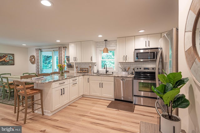 120 Robin Hood, Ocean Pines, MD 21811 - kitchen with stainless steel appliances, a peninsula, white cabinets, plenty of natural light, and recessed lighting
