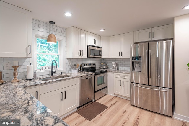 120 Robin Hood, Ocean Pines, MD 21811 - kitchen featuring appliances with stainless steel finishes, white cabinetry, light stone counters, tasteful backsplash, and recessed lighting