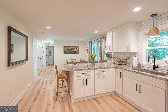 120 Robin Hood, Ocean Pines, MD 21811 - kitchen with light wood-style floors, a peninsula, white cabinetry, recessed lighting, and light stone countertops