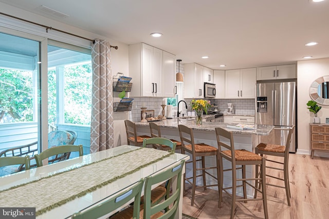120 Robin Hood, Ocean Pines, MD 21811 - kitchen featuring stainless steel appliances, light stone counters, tasteful backsplash, a peninsula, and recessed lighting
