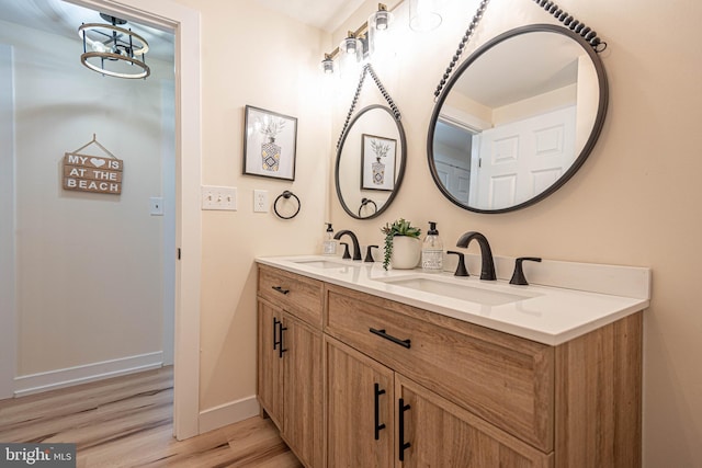 120 Robin Hood, Ocean Pines, MD 21811 - full bath with double vanity, wood finished floors, and a chandelier