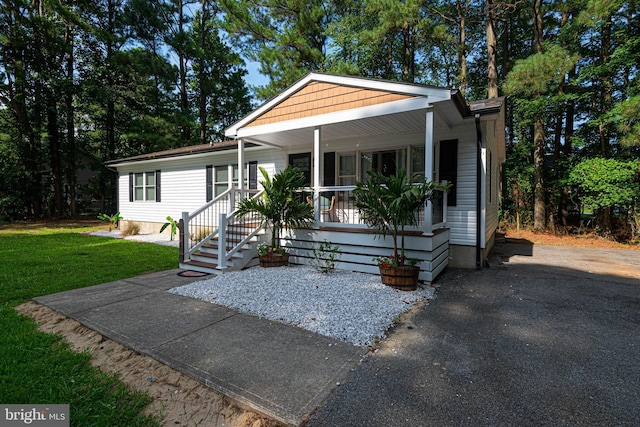 120 Robin Hood, Ocean Pines, MD 21811 - manufactured / mobile home with covered porch and a front lawn