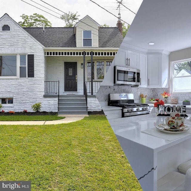 1204 Krueger Ave, Rosedale, MD 21237 - view of front of house featuring stone siding, a front yard, a shingled roof, covered porch, and area for grilling