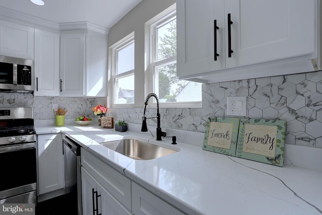 1204 Krueger Ave, Rosedale, MD 21237 - kitchen featuring stainless steel appliances, white cabinets, tasteful backsplash, and light stone countertops