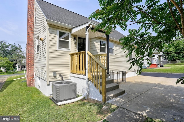 1204 Krueger Ave, Rosedale, MD 21237 - rear view of house with a shingled roof, a yard, and a chimney
