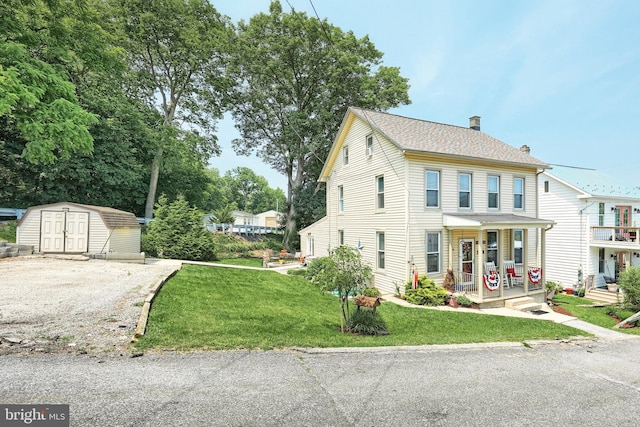 75 Railroad Ave, York Haven, PA 17370 - view of front facade featuring a storage shed, a chimney, a porch, and a front lawn