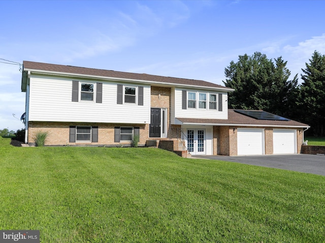 8175 Stone Bridge Rd, Greencastle, PA 17225 - split foyer home with a front lawn, asphalt driveway, french doors, an attached garage, and brick siding