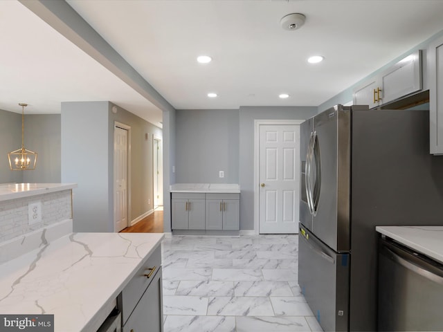 8175 Stone Bridge Rd, Greencastle, PA 17225 - kitchen featuring light marble finish floors, a chandelier, light stone counters, appliances with stainless steel finishes, and gray cabinets