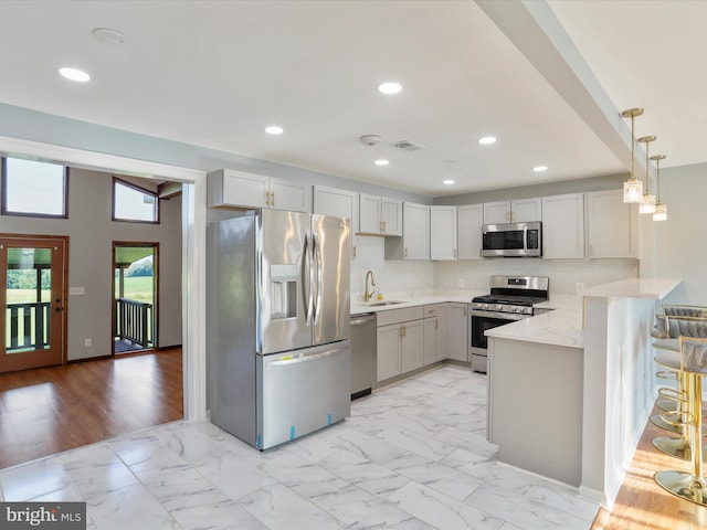 8175 Stone Bridge Rd, Greencastle, PA 17225 - kitchen featuring stainless steel appliances, a peninsula, recessed lighting, hanging light fixtures, and light marble finish floors