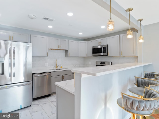 8175 Stone Bridge Rd, Greencastle, PA 17225 - kitchen featuring appliances with stainless steel finishes, gray cabinetry, light marble finish floors, light stone counters, and decorative backsplash