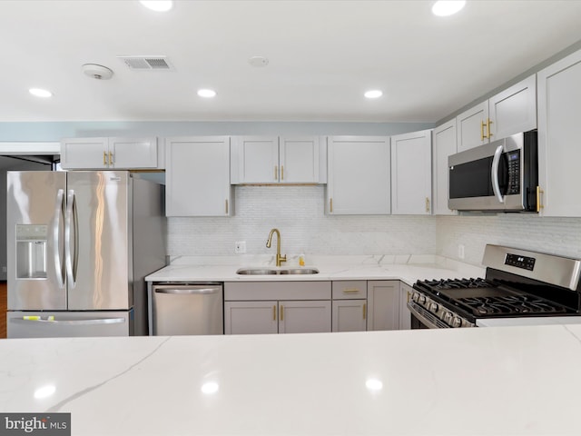 8175 Stone Bridge Rd, Greencastle, PA 17225 - kitchen with stainless steel appliances, decorative backsplash, light stone counters, and recessed lighting
