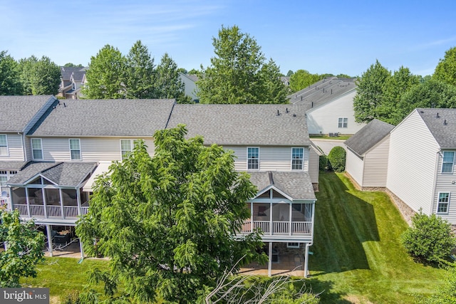 11037 Doxberry Cir Unit 15, Woodstock, MD 21163 - back of property with a sunroom, roof with shingles, a residential view, and a lawn