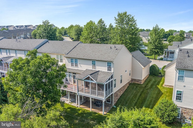 11037 Doxberry Cir Unit 15, Woodstock, MD 21163 - rear view of property featuring a sunroom, a shingled roof, a residential view, a yard, and stone siding