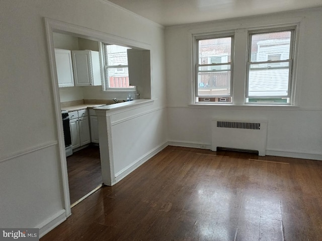 1420 Magee Ave, Philadelphia, PA 19111 - unfurnished dining area featuring radiator, plenty of natural light, and dark wood-type flooring