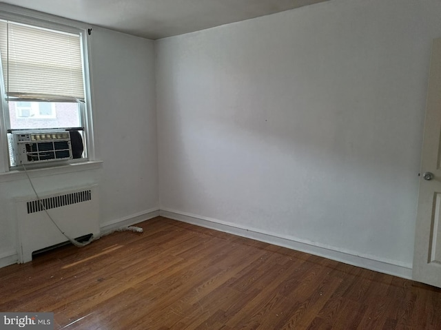 1420 Magee Ave, Philadelphia, PA 19111 - empty room featuring radiator heating unit, wood finished floors, and cooling unit