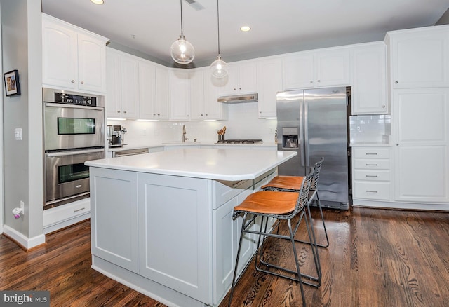 712 Arch Hall Ln, Alexandria, VA 22314 - kitchen with stainless steel appliances, a kitchen island, dark wood finished floors, white cabinetry, and recessed lighting
