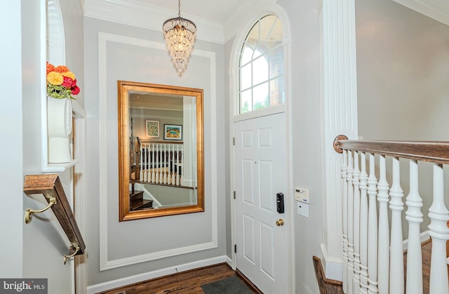 712 Arch Hall Ln, Alexandria, VA 22314 - entryway featuring a chandelier, dark wood-type flooring, and ornamental molding