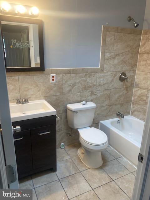 3720 Conshohocken Ave, Philadelphia, PA 19131 - full bath featuring vanity, tile walls, tile patterned floors, bathtub / shower combination, and a wainscoted wall