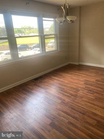 3720 Conshohocken Ave, Philadelphia, PA 19131 - empty room with dark wood-style flooring and a chandelier
