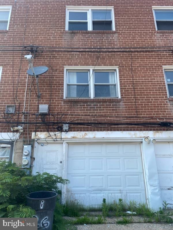 3720 Conshohocken Ave, Philadelphia, PA 19131 - view of side of home with brick siding and a garage
