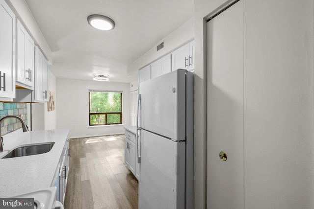 435 Christopher Ave Unit 23, Gaithersburg, MD 20879 - kitchen featuring freestanding refrigerator, dark wood-style flooring, white cabinets, and light stone counters