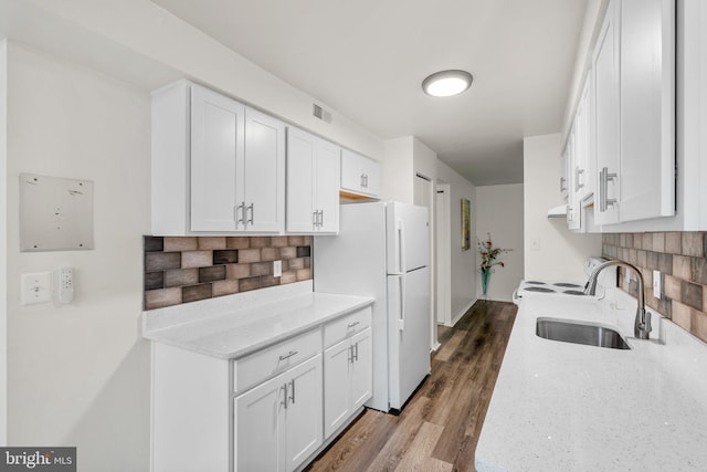 435 Christopher Ave Unit 23, Gaithersburg, MD 20879 - kitchen with freestanding refrigerator, decorative backsplash, white cabinets, and light stone countertops