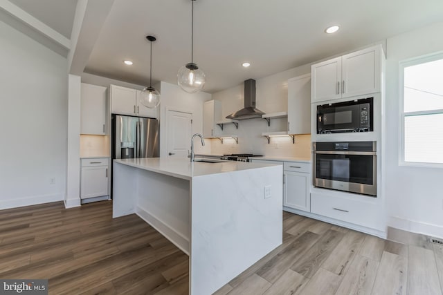 36365 Gate Dr, Georgetown, DE 19947 - kitchen with appliances with stainless steel finishes, island range hood, decorative backsplash, light countertops, and light wood-type flooring