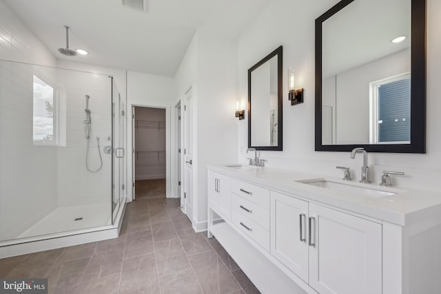 36365 Gate Dr, Georgetown, DE 19947 - bathroom with a stall shower, double vanity, recessed lighting, a spacious closet, and marble look tiles