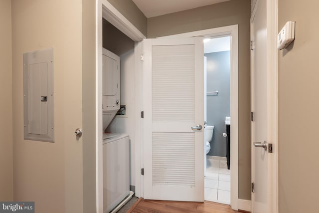 910 M St NW Unit 708, Washington, DC 20001 - laundry room featuring electric panel, stacked washing machine and dryer, and wood finished floors
