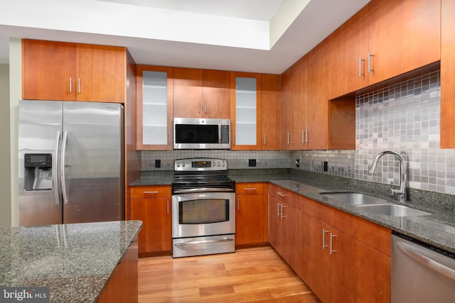 910 M St NW Unit 708, Washington, DC 20001 - kitchen featuring stainless steel appliances, dark stone counters, and decorative backsplash