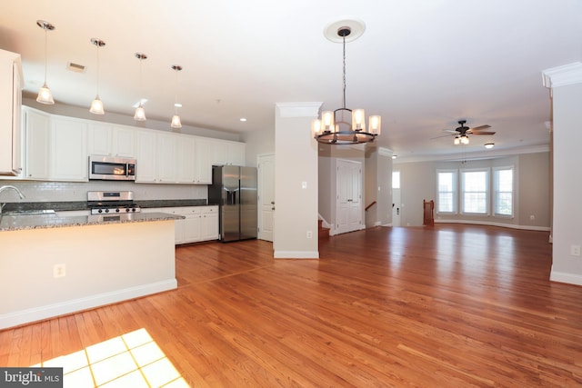 2066 Capstone Cir, Herndon, VA 20170 - kitchen with stainless steel appliances, ceiling fan, ornamental molding, light wood-type flooring, and white cabinets