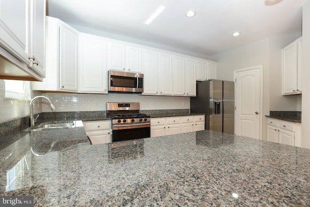 2066 Capstone Cir, Herndon, VA 20170 - kitchen featuring appliances with stainless steel finishes, dark stone countertops, white cabinetry, and recessed lighting