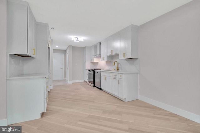 166 Neil Ct, Princeton, NJ 08540 - kitchen with stainless steel range with gas stovetop, wall chimney exhaust hood, light countertops, and light wood-type flooring