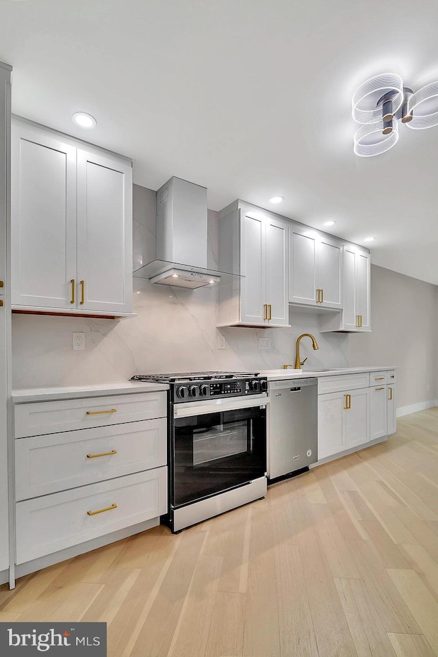 166 Neil Ct, Princeton, NJ 08540 - kitchen featuring dishwasher, black gas range, wall chimney exhaust hood, light wood-type flooring, and light countertops