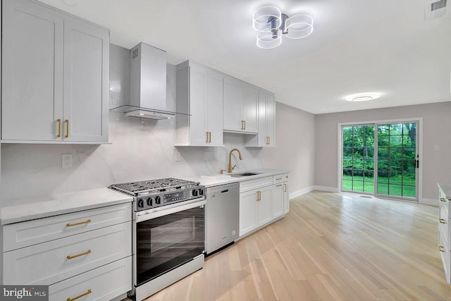 166 Neil Ct, Princeton, NJ 08540 - kitchen featuring appliances with stainless steel finishes, wall chimney exhaust hood, light wood-type flooring, light countertops, and white cabinets