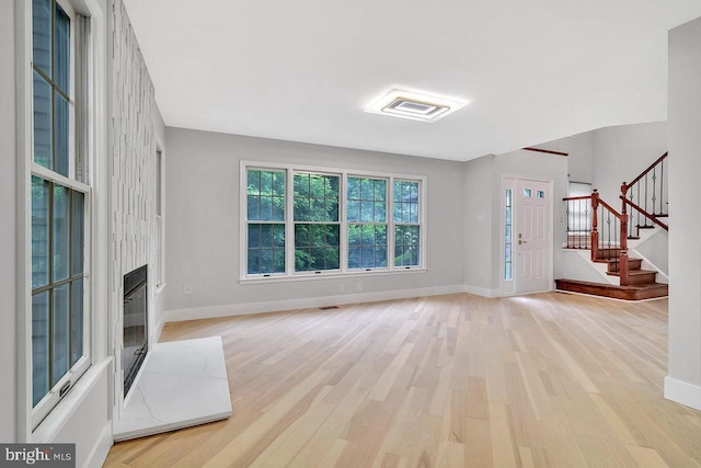 166 Neil Ct, Princeton, NJ 08540 - unfurnished living room with light wood-style floors, stairs, and a high end fireplace