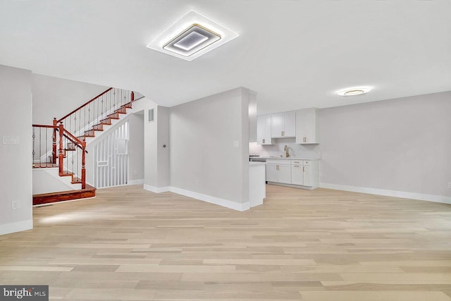 166 Neil Ct, Princeton, NJ 08540 - unfurnished living room featuring light wood-type flooring and stairs