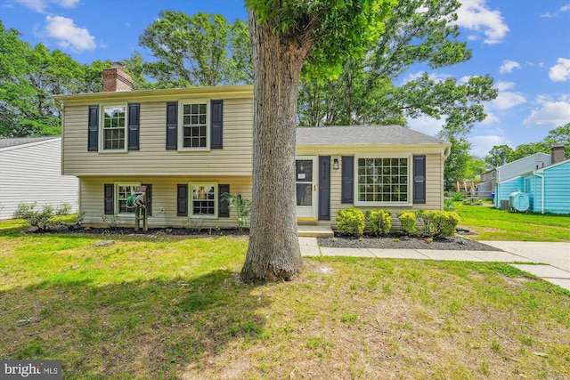 4376 Rock Ct, Waldorf, MD 20602 - view of front of house featuring a chimney and a front lawn