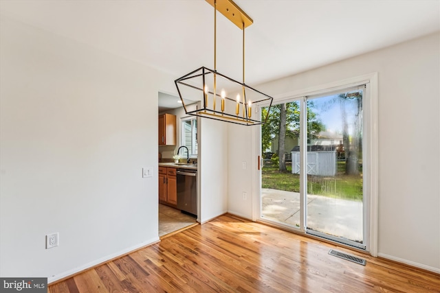 4376 Rock Ct, Waldorf, MD 20602 - unfurnished dining area featuring a chandelier and light wood-style flooring