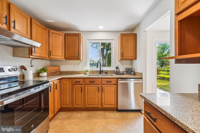 4376 Rock Ct, Waldorf, MD 20602 - kitchen with appliances with stainless steel finishes, under cabinet range hood, light stone counters, plenty of natural light, and recessed lighting