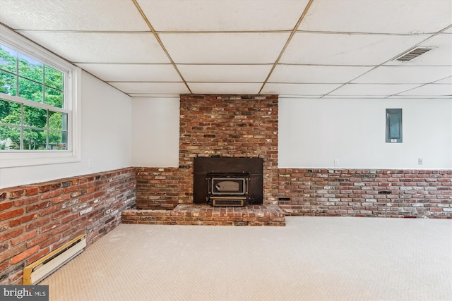 4376 Rock Ct, Waldorf, MD 20602 - unfurnished living room featuring a baseboard radiator, a paneled ceiling, brick wall, and a wood stove