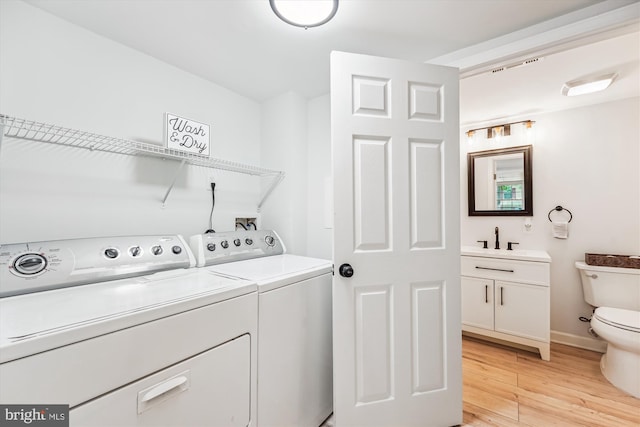 4376 Rock Ct, Waldorf, MD 20602 - laundry room with washer and clothes dryer and light wood-style flooring
