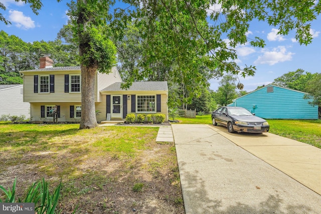 4376 Rock Ct, Waldorf, MD 20602 - tri-level home with a front yard, driveway, and a chimney