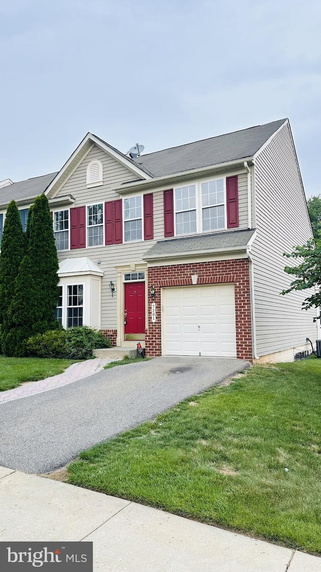 7201 Torpoint Ct, Hanover, MD 21076 - view of property with driveway, a garage, a front lawn, and brick siding