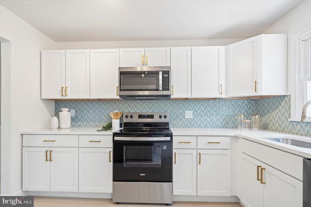 3402 Stevenswood Ct, Baltimore, MD 21244 - kitchen featuring appliances with stainless steel finishes, light countertops, white cabinets, and tasteful backsplash