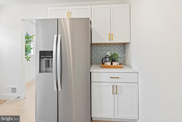 3402 Stevenswood Ct, Baltimore, MD 21244 - kitchen featuring stainless steel fridge, tasteful backsplash, light countertops, and white cabinetry